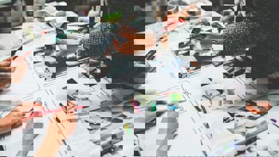 Image of the hands of people working on a magazine