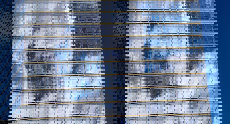 Clouds reflected off the glass of an office building