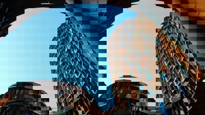 An architectural image of a wave-like building