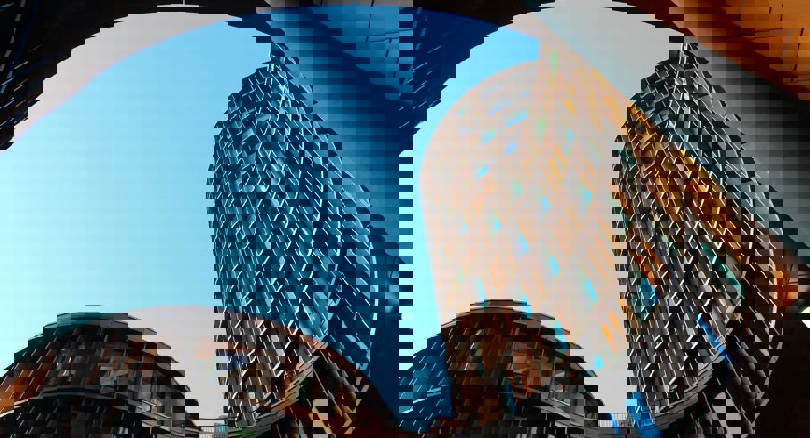 An architectural image of a wave-like building