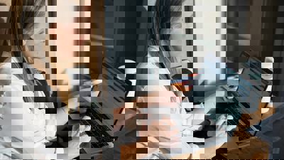 A lady sitting looking at a computer