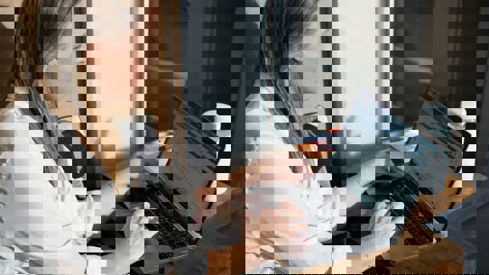 A lady sitting looking at a computer